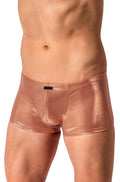 A close-up of a male model's lower torso wearing shiny metallic rose-gold boxer briefs against a plain white background.
