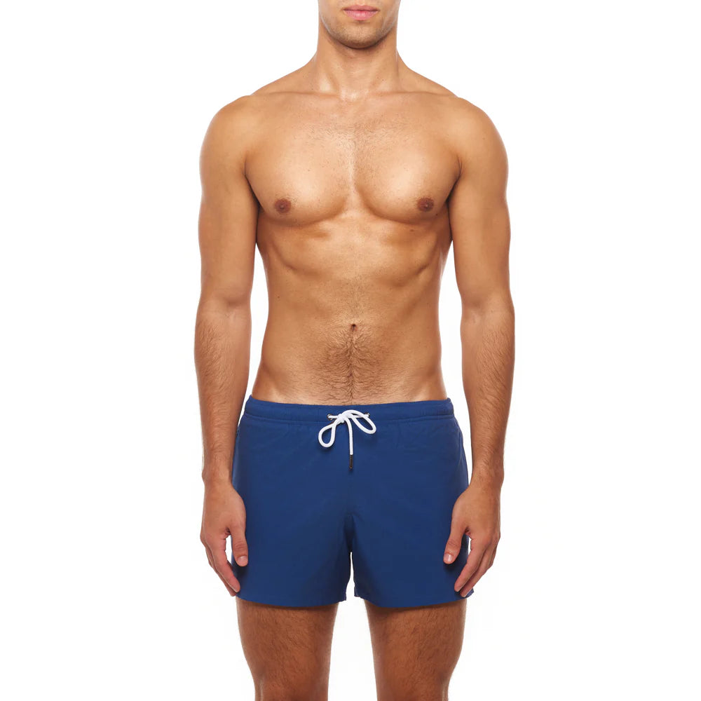 Man wearing blue swim shorts with a white drawstring on a white background