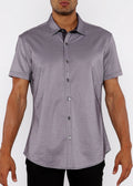 Man wearing a gray short-sleeve shirt on a white background